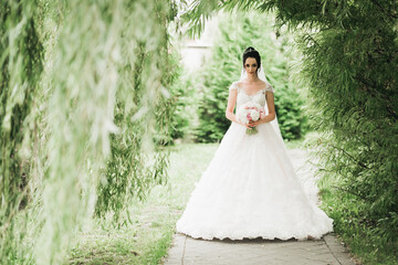 Portrait of stunning bride with long hair posing with great bouquet