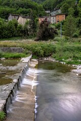 Mountain village with river and vegetation