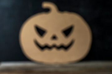 the shape of the halloween pumpkin in the background is completely blurred. No sharpness. Defocused.