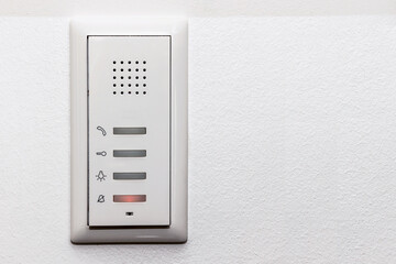 Intercom on White Wall with Microphone. Modern Door Bell, Electronic Lock inside Apartment. Copy...