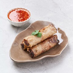 Crispy Spring Rolls with chili sauce served in a dish isolated on grey background side view of vietnam food