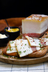Salo. National Ukrainian product. Freshly salted bacon with spices on the board.