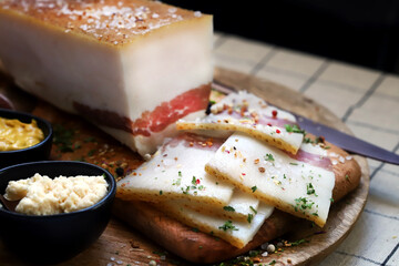 Salo. National Ukrainian product. Freshly salted bacon with spices on the board.