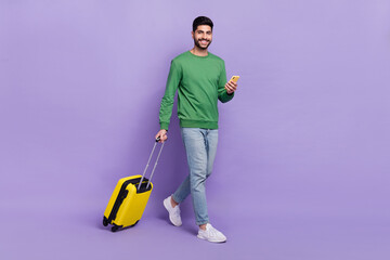 Full length photo of young hispanic arabian guy hold gadget tourist use roaming wear trendy green...