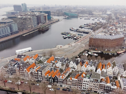 Waterway with moorage dividing part of city in Netherlands