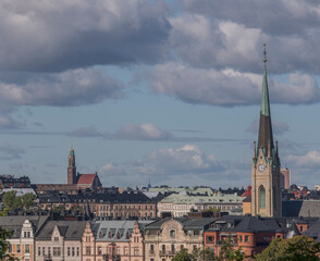 Naklejka premium Roofs, dorms, tin facades of churches and apartment buildings in the districts Östermalm and Vasastan a sunny autumn day in Stockholm