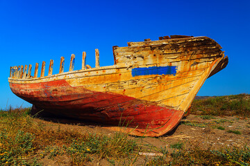 fishing boat wreck front view of keel standing on land with grass