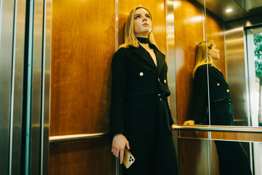 Young transgender person inside the  elevator 