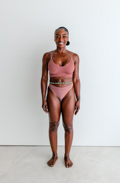 Athletic black woman wearing bra and thong