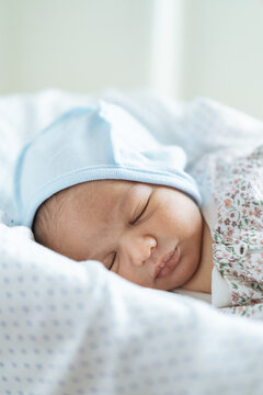 Newborn baby in his bed at home