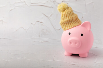 Savings concept. Piggy bank and money on a yellow textural background. A piggy bank in a warm...