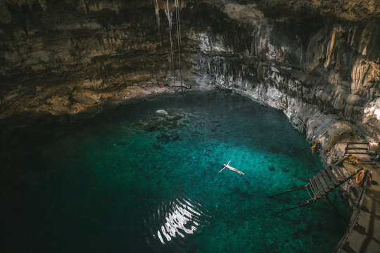 Woman swimming in Cenote in Yucatan, Mexico