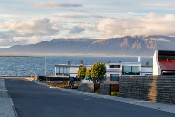 coast street with residential buildings on the bay in reykjavik