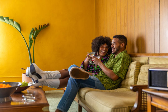 Hip Black Couple laughing enjoying martini cocktail 