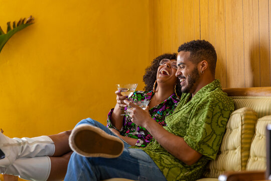 African American Couple laughing enjoying martini cocktail 