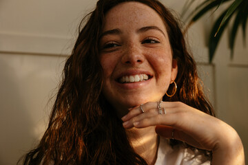 Optimistic freckled teen at home
