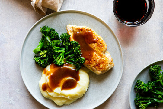 Chicken gravy, mashed potato and broccolini vegetable
