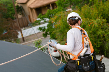 Woman roofing with protective equipment