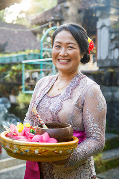 Beautiful Balinese woman smiling and looking at camera