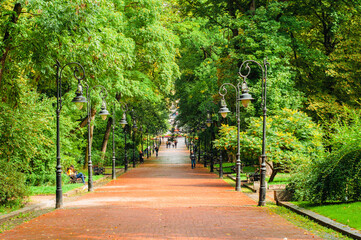 landscape, alley, park, streets with benches, lanterns and trees, autumn is coming, summer is ending