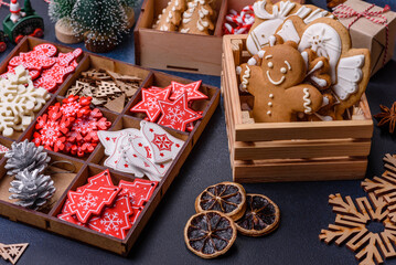 Christmas tree wooden toys in white and red colors, gingerbread and dried lemon and grapefruit slices