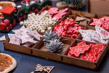 Christmas tree wooden toys in white and red colors, gingerbread and dried lemon and grapefruit slices