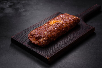 Delicious fresh ground beef meat roll with cheese, tomatoes and sweet peppers
