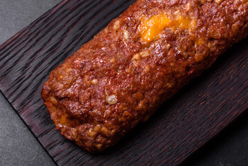 Delicious fresh ground beef meat roll with cheese, tomatoes and sweet peppers