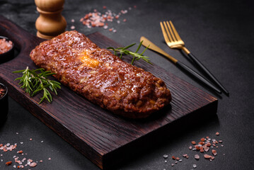 Delicious fresh ground beef meat roll with cheese, tomatoes and sweet peppers