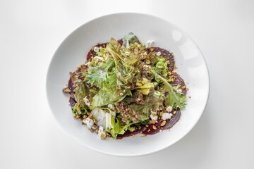Beets Goat Cheese Salad served in a dish isolated on grey background top view