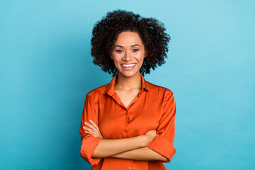 Portrait of charming lady crossed hands toothy smile look camera isolated on blue color background