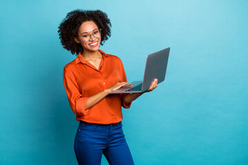 Portrait of beautiful trendy cheery wavy-haired girl using laptop study education isolated on vivid blue color background