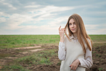 Portrait of a young beautiful fair-haired girl in the autumn park.