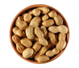 Peanuts with shells in clay pot isolated on white, top view
