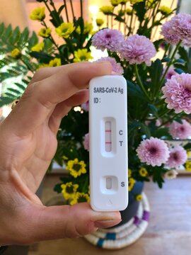 UGC women hand showing a positive test at home