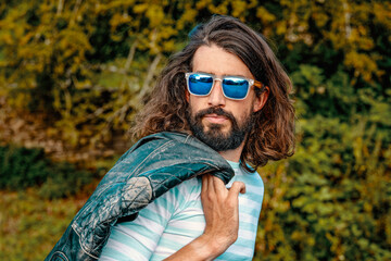 Man wearing sunglasses riding a retro motorbike