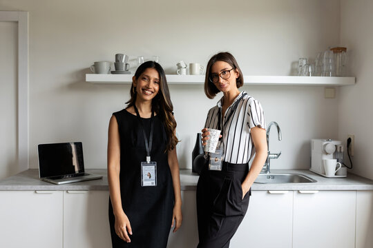 Businesswomen in office having coffee
