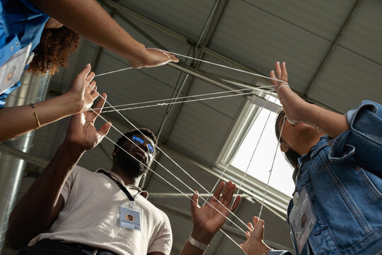 Business staff activity with entwined rope