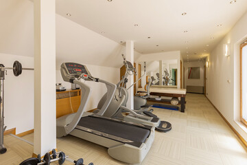 Interior of a small hotel gym with equipment