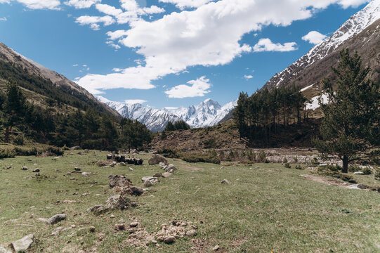 Snowy mountains and valley on cloudy day