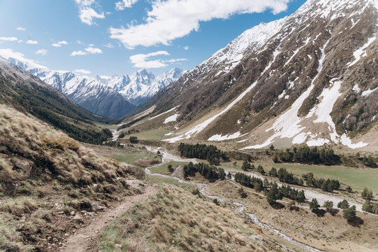 Snowy mountains and valley on cloudy day
