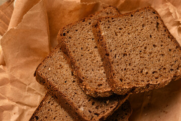 still life of food in a rural style on a dark wood background, sliced rye bread, concept of fresh vegetables and healthy food