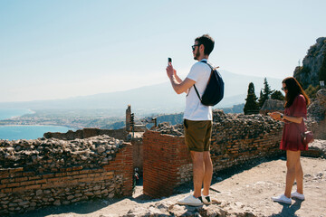 Tourists taking pictures from ancient ruins of the views of the sea