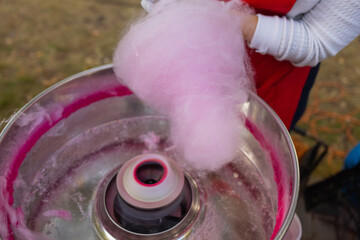 People make cotton candy for children close-up.