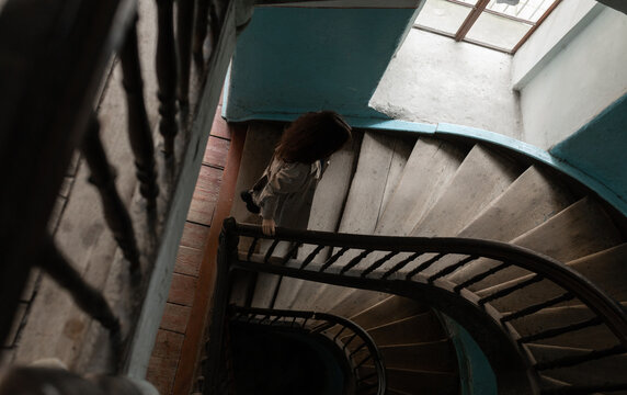 a woman  rises in the old entrance