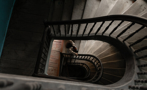 woman climbing a spiral staircase