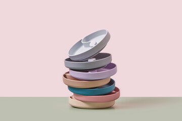Silicone kids plates lying in stack over duotone background