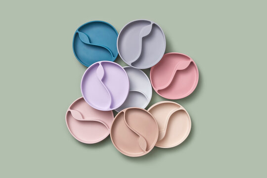 Pile of pastel colored silicone plates for kids