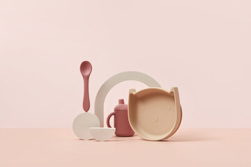 Children's tableware: plate with spoon and cup.