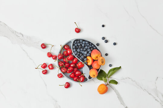 Baby plate filled with berries and fruits.